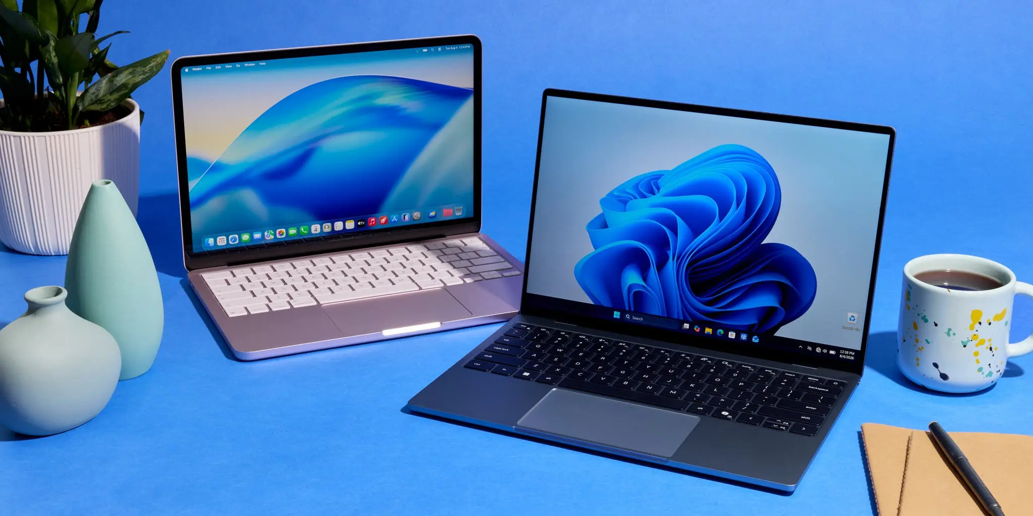 A student and a shop assistant comparing two laptops in a store